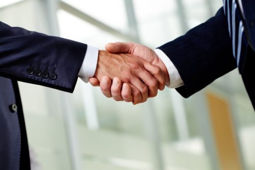 12620153 - senior businessman shaking hands as a sign of a successfully concluded deal